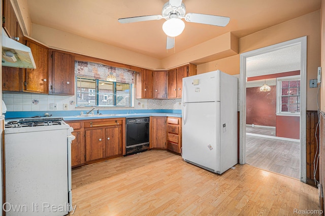74 Chestnut St, River Rouge, MI 48218 - kitchen featuring white appliances, brown cabinets, light wood finished floors, and under cabinet range hood