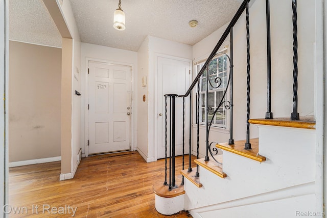 74 Chestnut St, River Rouge, MI 48218 - entrance foyer featuring stairs, hardwood / wood-style flooring, and a textured ceiling