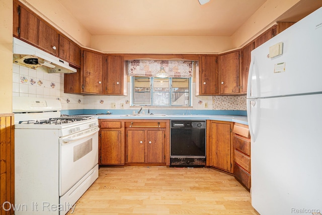 74 Chestnut St, River Rouge, MI 48218 - kitchen featuring white appliances, light wood-style flooring, and brown cabinets