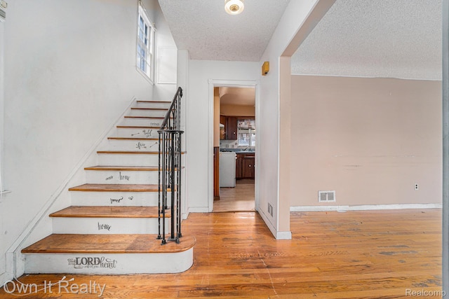 74 Chestnut St, River Rouge, MI 48218 - staircase featuring wood finished floors and a textured ceiling
