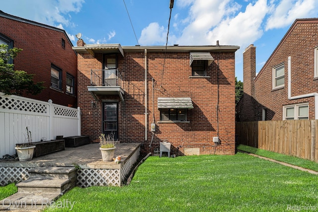 74 Chestnut St, River Rouge, MI 48218 - rear view of house featuring brick siding, a fenced backyard, and a deck