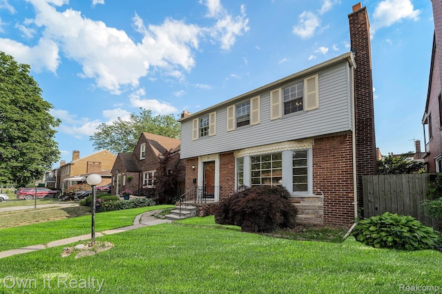 74 Chestnut St, River Rouge, MI 48218 - colonial house featuring a chimney and brick siding