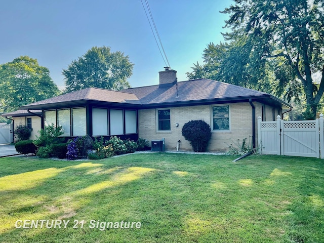 1751 Lathrup Ave, Saginaw, MI 48638 - back of house featuring a gate, roof with shingles, brick siding, and a chimney