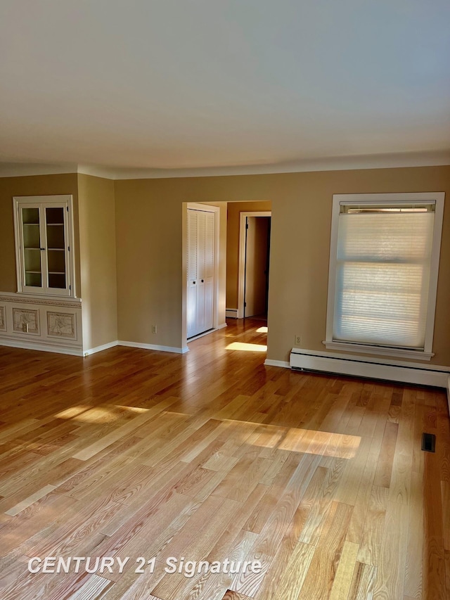 1751 Lathrup Ave, Saginaw, MI 48638 - spare room with a baseboard radiator and light wood-type flooring
