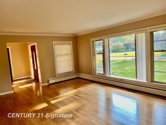 1751 Lathrup Ave, Saginaw, MI 48638 - empty room featuring a baseboard heating unit and light wood-type flooring