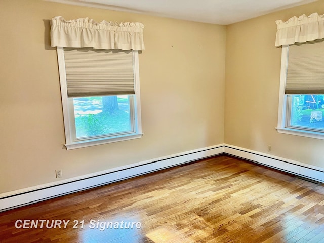 1751 Lathrup Ave, Saginaw, MI 48638 - spare room with healthy amount of natural light, wood finished floors, and a baseboard heating unit