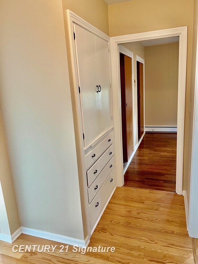 1751 Lathrup Ave, Saginaw, MI 48638 - corridor with baseboard heating and light wood-type flooring
