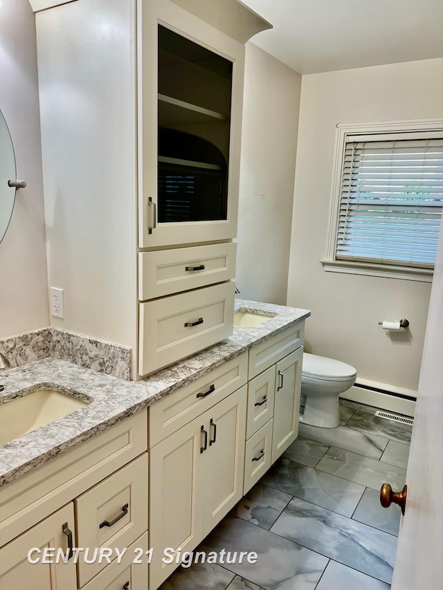 1751 Lathrup Ave, Saginaw, MI 48638 - full bathroom with a baseboard heating unit, double vanity, and marble look tile flooring