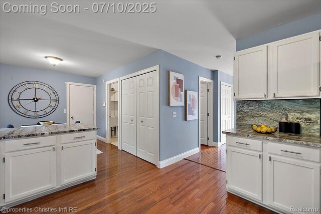 25426 Lindenwood Ln, Southfield, MI 48033 - kitchen featuring white cabinetry, backsplash, and dark wood-style flooring
