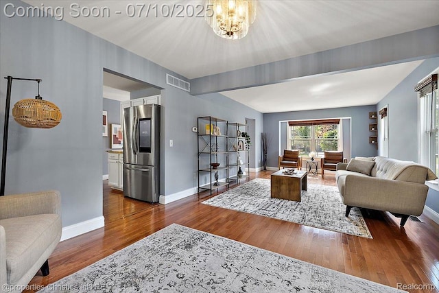25426 Lindenwood Ln, Southfield, MI 48033 - living room featuring dark wood finished floors and a chandelier