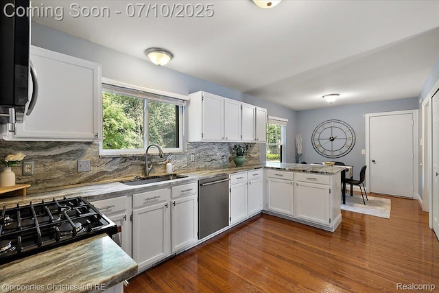 25426 Lindenwood Ln, Southfield, MI 48033 - kitchen with appliances with stainless steel finishes, white cabinets, a peninsula, and decorative backsplash