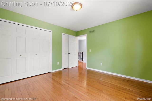 25426 Lindenwood Ln, Southfield, MI 48033 - unfurnished bedroom with light wood-type flooring and two closets