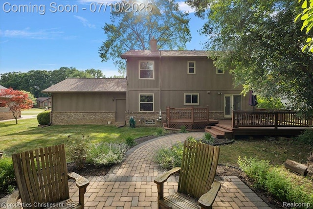 25426 Lindenwood Ln, Southfield, MI 48033 - rear view of property featuring a deck, a yard, a chimney, a patio, and brick siding