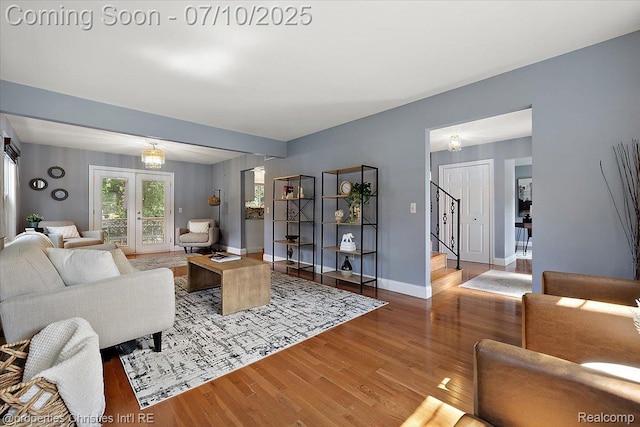 25426 Lindenwood Ln, Southfield, MI 48033 - living area featuring wood finished floors, stairway, and french doors
