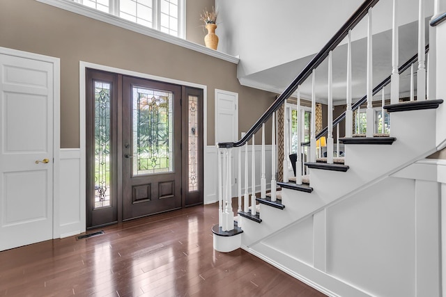 3800 Guest Rd, Jackson, MI 49203 - foyer featuring a high ceiling, wood finished floors, plenty of natural light, stairway, and a wainscoted wall