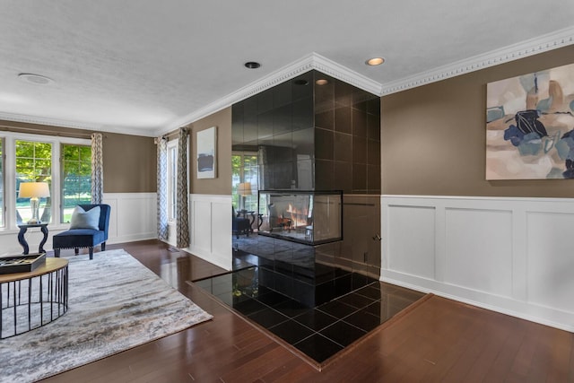 3800 Guest Rd, Jackson, MI 49203 - interior space featuring a decorative wall, crown molding, wainscoting, wood finished floors, and recessed lighting