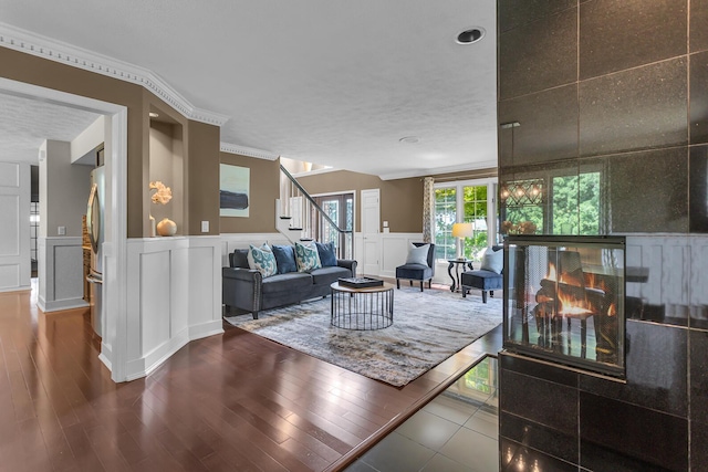 3800 Guest Rd, Jackson, MI 49203 - living room with a decorative wall, stairway, wood finished floors, wainscoting, and recessed lighting