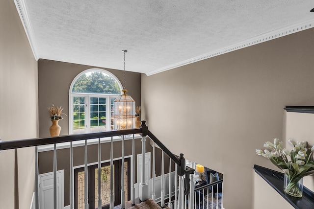 3800 Guest Rd, Jackson, MI 49203 - stairs featuring a textured ceiling, a chandelier, and crown molding