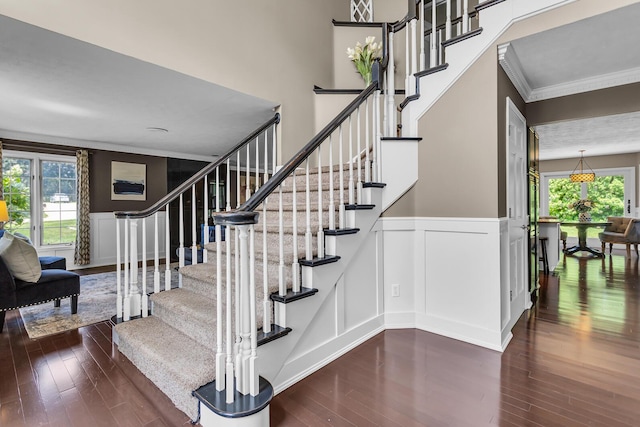 3800 Guest Rd, Jackson, MI 49203 - stairway with ornamental molding, healthy amount of natural light, hardwood / wood-style floors, a decorative wall, and wainscoting