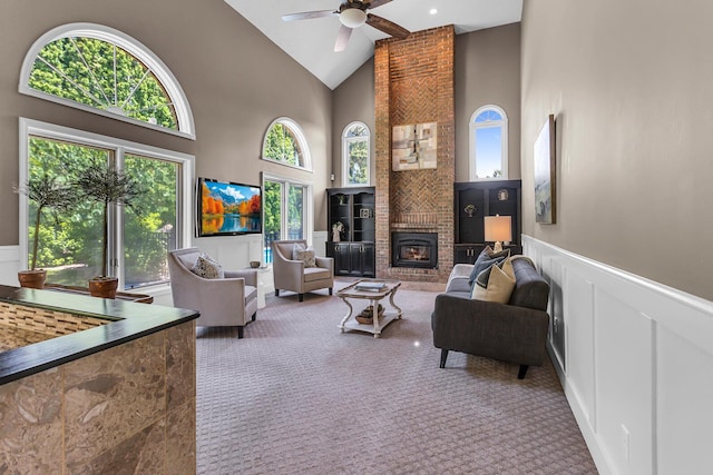 3800 Guest Rd, Jackson, MI 49203 - living area with carpet, a decorative wall, high vaulted ceiling, a ceiling fan, and a wainscoted wall