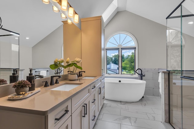 3800 Guest Rd, Jackson, MI 49203 - full bathroom featuring double vanity, a freestanding bath, a stall shower, marble look tile flooring, and high vaulted ceiling