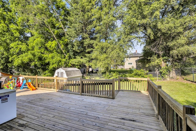 226 Briscoe Pl, Jackson, MI 49203 - wooden deck with a storage shed, a fenced backyard, and a playground