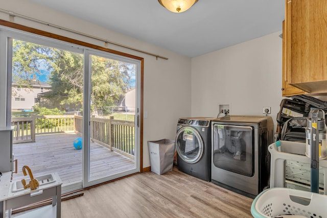 226 Briscoe Pl, Jackson, MI 49203 - laundry room with cabinet space, separate washer and dryer, and light wood-type flooring