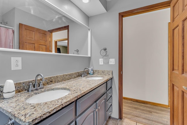 226 Briscoe Pl, Jackson, MI 49203 - full bath featuring double vanity and wood finished floors