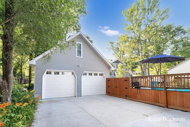 140 S Monroe St NE, Rockford, MI 49341 - view of side of home featuring a detached garage and an outbuilding