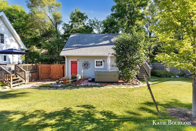 140 S Monroe St NE, Rockford, MI 49341 - view of front of home featuring a hot tub, stairs, roof with shingles, a gate, and a wooden deck