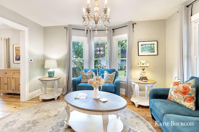140 S Monroe St NE, Rockford, MI 49341 - living room featuring a chandelier and light wood-style flooring