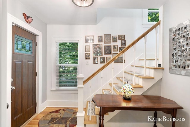 140 S Monroe St NE, Rockford, MI 49341 - foyer with stairs and wood finished floors