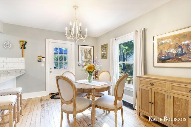 140 S Monroe St NE, Rockford, MI 49341 - dining space with a chandelier and light wood finished floors