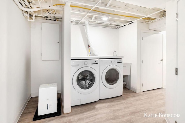 140 S Monroe St NE, Rockford, MI 49341 - washroom featuring independent washer and dryer and light wood-style flooring