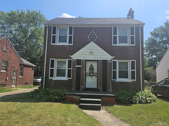15900 Murray Hill St, Detroit, MI 48227 - view of front of home with a front yard, a chimney, and brick siding
