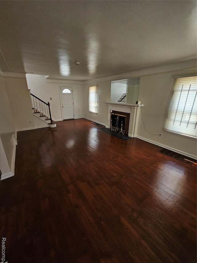 15900 Murray Hill St, Detroit, MI 48227 - unfurnished living room with ornamental molding, stairs, a fireplace, and wood finished floors