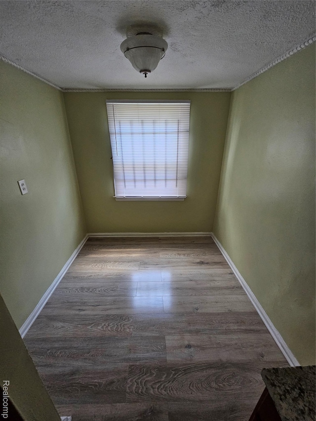 15900 Murray Hill St, Detroit, MI 48227 - empty room with wood finished floors and a textured ceiling