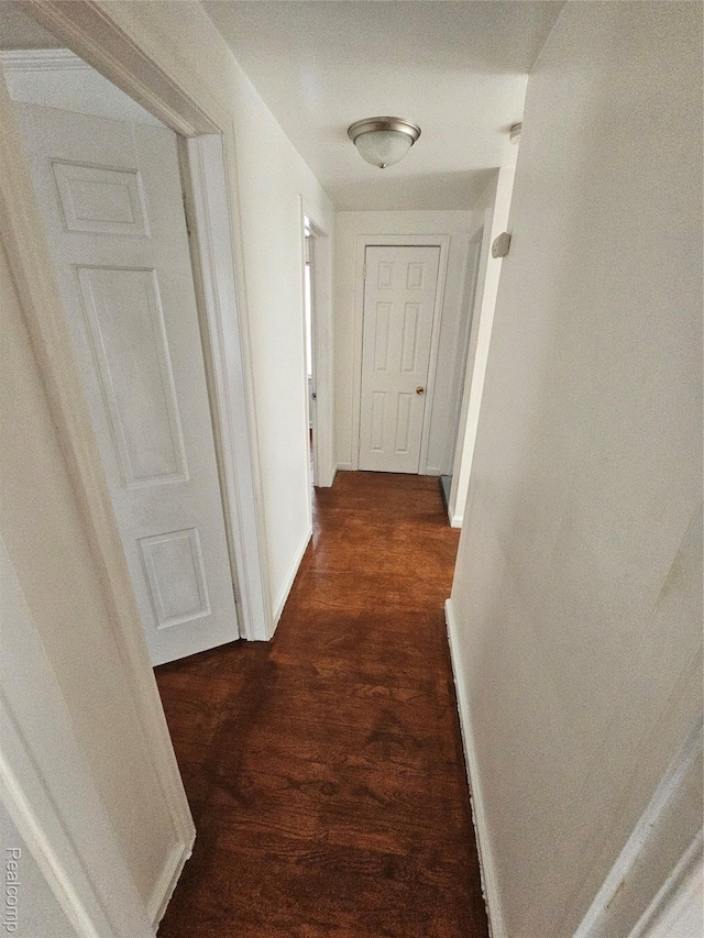 15900 Murray Hill St, Detroit, MI 48227 - hallway featuring dark wood-style flooring and baseboards