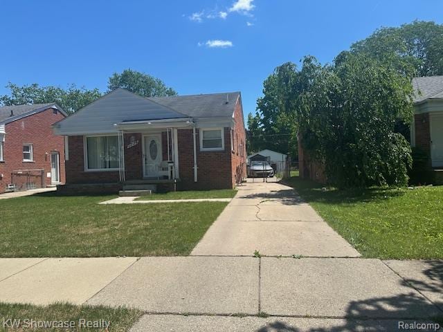 9624 Winston, Redford, MI 48239 - bungalow-style home with a front yard, concrete driveway, and brick siding