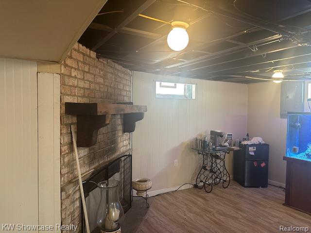 9624 Winston, Redford, MI 48239 - below grade area featuring freestanding refrigerator, a fireplace, and wood finished floors