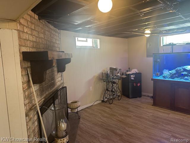 9624 Winston, Redford, MI 48239 - below grade area with wood finished floors and a large fireplace