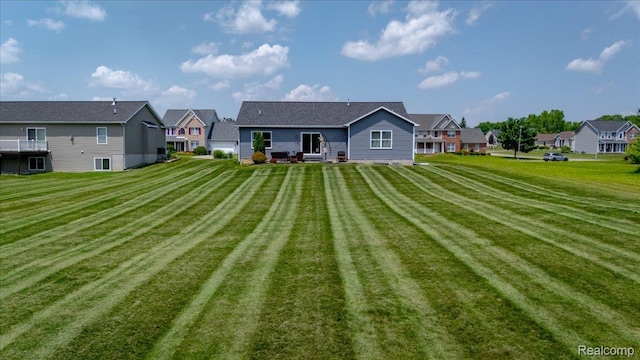 5606 Chatham Ln, Grand Blanc, MI 48439 - rear view of house featuring a lawn and a residential view