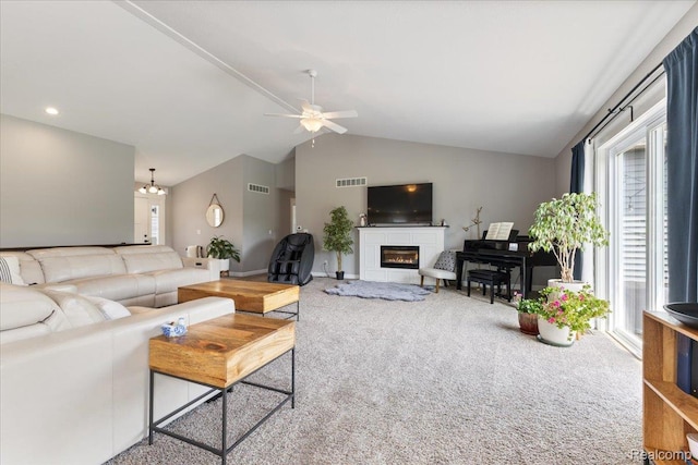 5606 Chatham Ln, Grand Blanc, MI 48439 - living area featuring carpet flooring, vaulted ceiling, a ceiling fan, a glass covered fireplace, and a chandelier