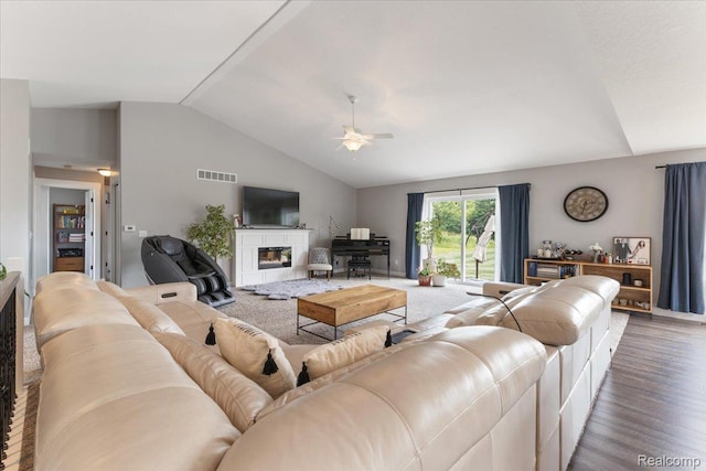 5606 Chatham Ln, Grand Blanc, MI 48439 - living area with vaulted ceiling, ceiling fan, wood finished floors, and a glass covered fireplace