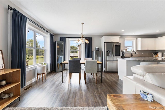 5606 Chatham Ln, Grand Blanc, MI 48439 - dining space featuring a chandelier, dark wood finished floors, and recessed lighting