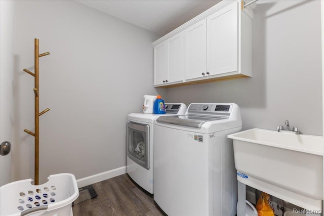 5606 Chatham Ln, Grand Blanc, MI 48439 - washroom featuring washing machine and clothes dryer, cabinet space, dark wood-style flooring, and a textured ceiling