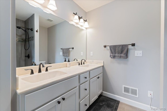 5606 Chatham Ln, Grand Blanc, MI 48439 - bathroom with double vanity, a shower, and wood finished floors