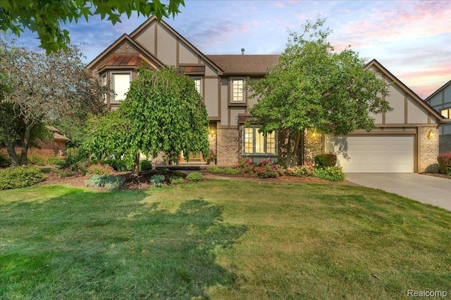 24842 White Plains Dr, Novi, MI 48374 - tudor-style house featuring driveway, a front yard, a garage, and stucco siding