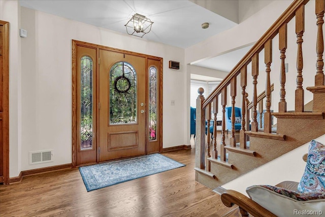24842 White Plains Dr, Novi, MI 48374 - foyer with wood finished floors, stairs, and a chandelier