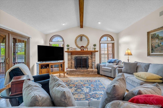 24842 White Plains Dr, Novi, MI 48374 - living area featuring a textured ceiling, wood finished floors, and a brick fireplace